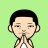 Pixelated character with short dark hair, light skin tone, and closed eyes in a prayer pose against solid green background.