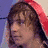A four- shows a person with brown hair in three distinct poses and one blank , wearing red hooded clothing against varied backgrounds