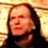 Static 48x48 pixel buddy icon showing a close-up of a person with long dark hair against a bright yellow background, rendered in low-resolution pixel art style.