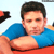 Static pixelated image of a person in blue shirt with arms crossed, partial red background and black shape on left edge.