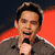 Four distinct pixelated images of a person in various poses and backgrounds, including holding a microphone and making hand gestures.