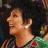 A contact sheet of two animated frames showing a woman with short dark hair in profile, wearing earrings and a green patterned top, next to a red house icon with 'ARRESTED DEVELOPMENT' text below it.