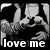 Pixelated grayscale image of two figures in an embrace with text 'love me' at the bottom.