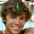 A pixelated image of a person with brown hair smiling, overlaid with green text reading 'i LOVE RYAN =]' across three sections.