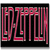 Pixelated static icon featuring stylized pink text on a black background with subtle gradient effects and vertical alignment.