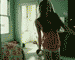 Animated sequence showing a woman in a room with windows, performing actions like turning and raising arms