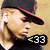 Pixelated image of a person wearing a dark cap with red trim and a black shirt, with text overlays in red and white.