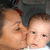 A woman kisses a baby's cheek in a four- with slight variations in facial expression and head position