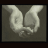 Two light-colored hands clasped in a heart shape against a dark gray background with pixelated text reading 'hold a true friend with both friends' on the right.