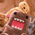Pixelated cartoon character with brown body, pink hair bow, and open mouth showing red tongue and white teeth against brown background.