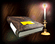 A book with a yellow bookmark rests on a dark surface beside a lit candle with a glowing flame.