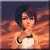 Pixelated image of a person with dark hair wearing a white top and gold bracelet, holding a white object against a gradient background.