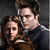 Two figures in a close embrace, one with brown hair and the other with dark hair, against a dark background.