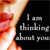 A pixelated close-up of a person's mouth and chin on the left, with a black background containing gray text reading "I am thinking about you" on the right.