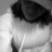 Pixelated grayscale image of a figure with dark hair and light clothing, partially cropped at the top and bottom.