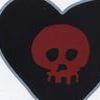A heart-shaped icon with a black interior and white border contains a red skull with dark eye sockets and a mouth, set against a dark background.