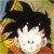 Pixelated static image of a character with spiky black hair, white face, and orange clothing against a yellowish background.