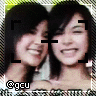 Two women with short black hair smiling closely together in a of with visible cropping marks and text overlays