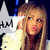 A person with long blonde hair wearing a light-colored top, positioned against a dark background with white star shapes and blue accents.