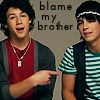 Static image of two young men with text "blame my brother" above them, one pointing at the other against a plain background.