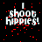 Black background with red pixelated splatters and white text reading "I shoot Hippies!" in a pixelated font.