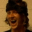 A pixelated image of a person with dark hair and a black top against a light background, next to blue text reading "i LOVE Tim FOREMAN!" on a solid blue field.