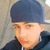 A person wearing a dark blue cap and black hoodie appears in four -aligned with subtle facial expression changes