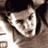 Static 48x48 pixel icon showing a close-up of a person's face with dark hair and light skin tones, rendered in low-resolution grayscale pixels.