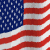 Animated American flag with red and white stripes, blue field of white stars, waving motion.