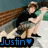 Pixelated image of two figures in a close embrace, one with long brown hair and dark clothing, the other in light clothing with a green shoulder, with blue text reading "Justin" and a blue heart symbol at the bottom.