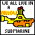 Pixel art icon of a yellow submarine with red checkered patterns, surrounded by text reading "WE ALL LIVE IN A YELLOW SUBMARINE" in black and orange pixelated letters.