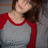 Pixelated image of a person with brown hair wearing a red and gray raglan-style shirt, head tilted back, mouth slightly open, against a gray background.
