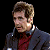 A pixelated contact sheet showing two frames of an animated icon featuring a man in a dark jacket and red shirt on the left, with green text reading "Original Icons .com" on a solid green background to the right.