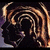 A pixelated static image shows a swirling vortex of brown and orange tones against a dark background with subtle purple and gray accents.