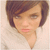 Static pixelated image of a person's face with short brown hair and light skin, cropped to show only the upper portion against a plain background.