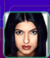 A pixelated portrait of a person with long dark hair and red lips, next to yellow text reading "Miss World 2000" on a black background.