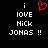 Black background with white pixelated text reading 'i LOVE NICK JONAS !!' and a red heart symbol above the first 'i'.