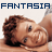 Static pixelated image featuring a person lying down with brown hair, wearing light-colored clothing, and the word "FANTASIA" in dark blue block letters above them on a white background.