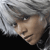 Pixelated close-up of a person with light skin and short white hair, wearing a dark top against a gray background.