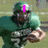 A football player in a green uniform holding a ball, with changing pink text overlays across three