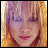 Pixelated image of a person with light brown hair and purple eyeshadow, next to pink text reading 'hilary duff' on white background.