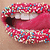 A mouth with sprinkled lips, tongue extended, and teeth visible in a static image.