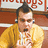A pixelated image shows a person in a yellow jacket with hands near the chest, next to blue background text reading 'eat pot eat' and partial red-and-white signage.