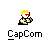 Pixel art character with yellow hair and red eyes holding a guitar, wearing black and yellow outfit with red scarf, standing on gray background with "CapCom" text below.