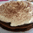 A split-screen image shows a close-up of a layered cake on the left and green pixelated text on a purple background on the right.