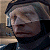 Pixelated image of a person with light hair wearing dark clothing, next to green text reading 'Original Icons .com' on a solid background.
