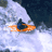 Animated sequence of a person in an orange kayak navigating turbulent white water against dark background.