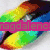 Rainbow gradient shape with pink text overlay on left, silver lips with blue-green 'RBD' letters on right.