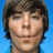 Pixelated image of a person with brown hair against blue background, next to red text on black background reading 'All I want 4 christmas is...... Zac Efron'