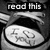 Black-and-white pixelated image with 'read this' text above a circular object containing indistinct symbols.